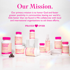 Assortment of Amy Suzanne products standing next to each other and on glass prisms. Our primary mission is to honor God and foster greater positivity in communities, leaving out world a little better than when we found it. 